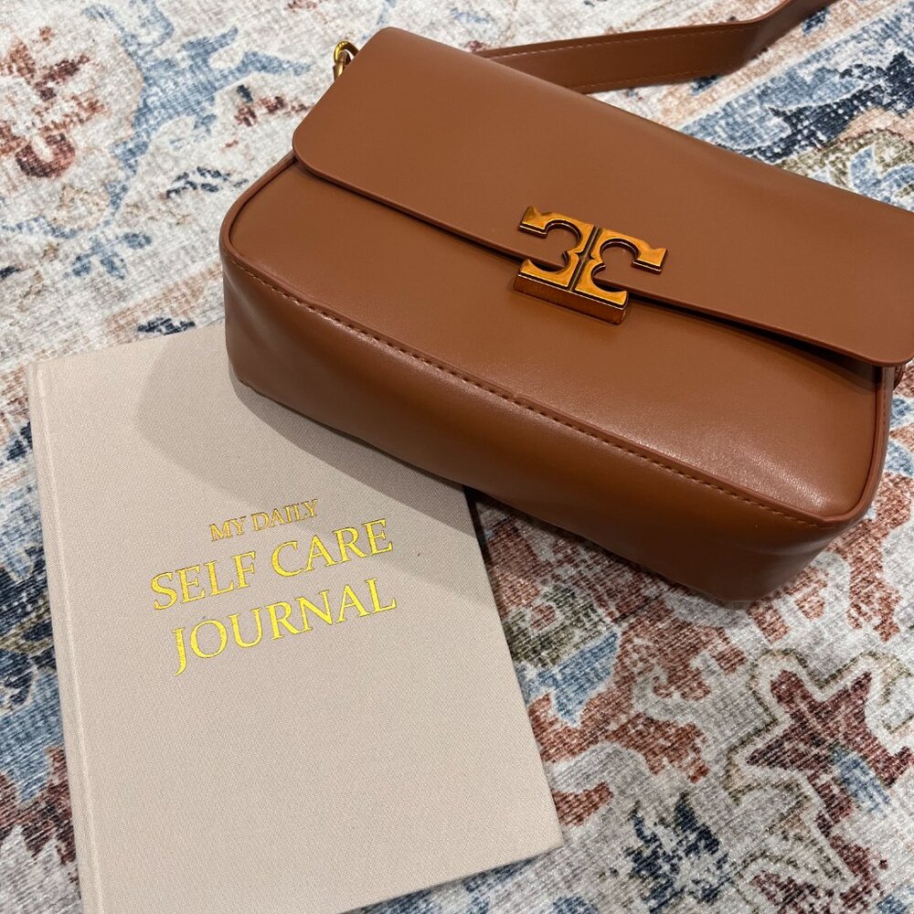 Brown leather hand bag with decorative gold chain